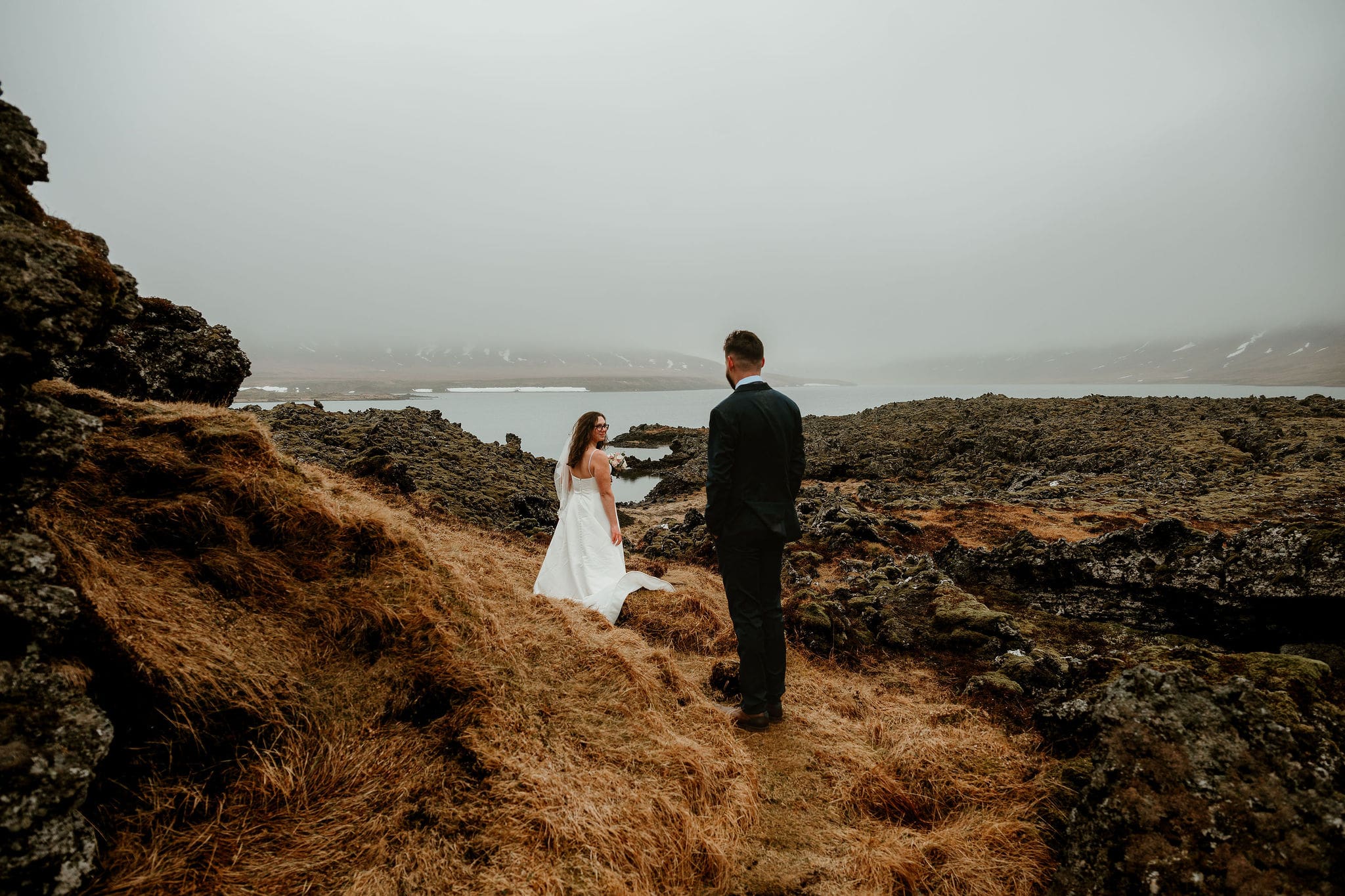 Elopement couple gazing at each other in a field of ancient lava rock