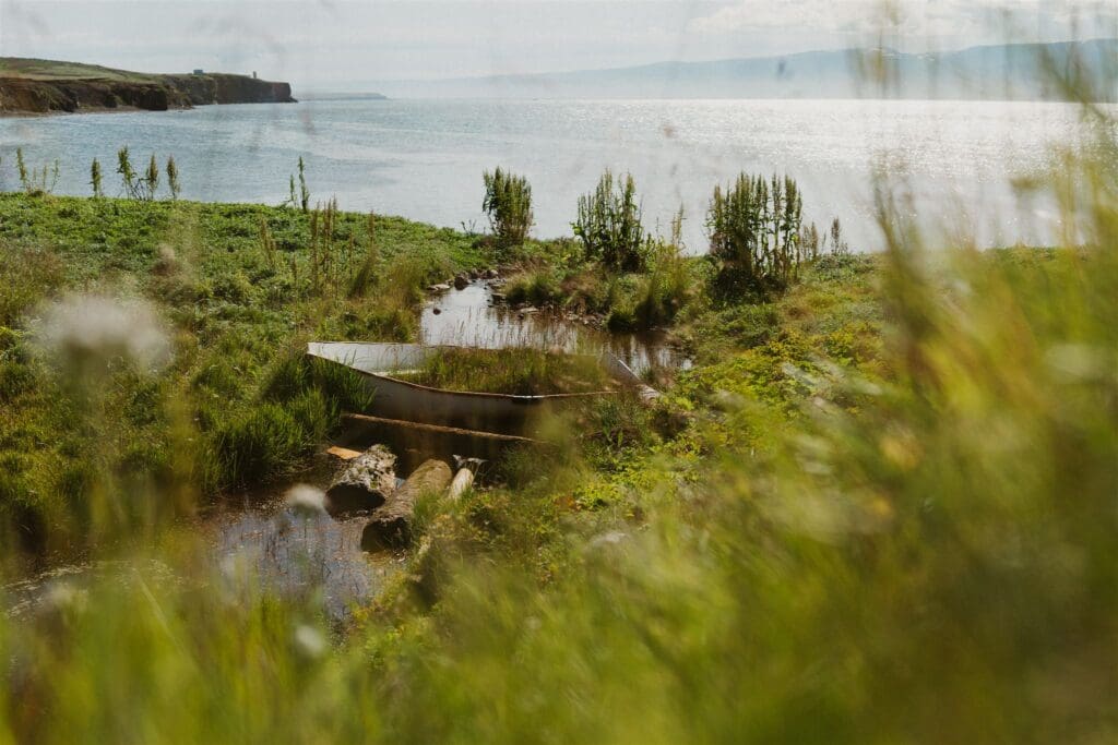 Quiet coastal scene in North Iceland during an elopement, with ocean views, grassy cliffs, and peaceful light.
