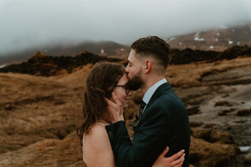 Couple sharing a quiet moment in Snæfellsnes Peninsula in Iceland during a romantic elopement.