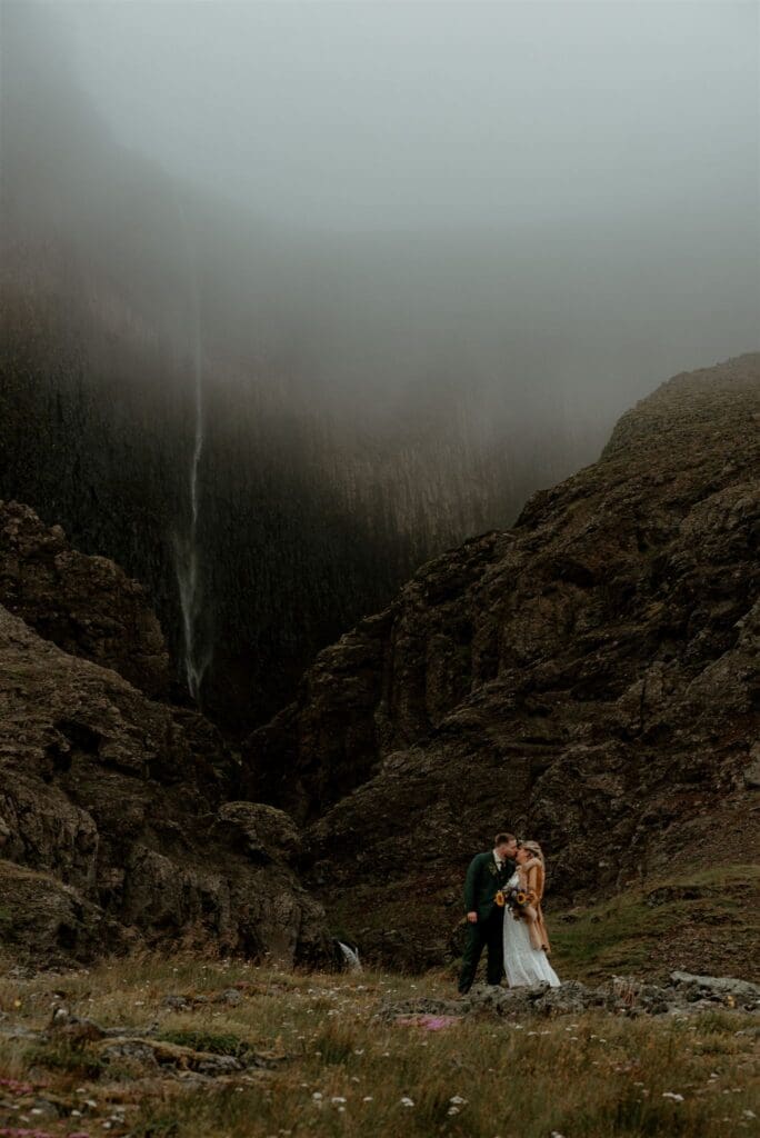 Couple eloping in Iceland at a remote, moody waterfall location