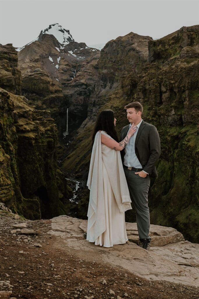 Intimate couple portrait at Múlagljúfur Canyon during an Iceland elopement, framed by steep green canyon walls.